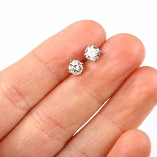 116 - A pair of 18ct white gold 1.01ct solitaire diamond stud earrings, plain 4-claw setting with modern r... 