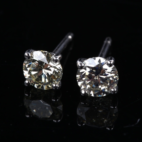 116 - A pair of 18ct white gold 1.01ct solitaire diamond stud earrings, plain 4-claw setting with modern r... 