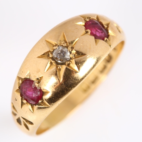 124 - An early 20th century 18ct gold three stone ruby and diamond gypsy ring, set with oval mixed-cut rub... 