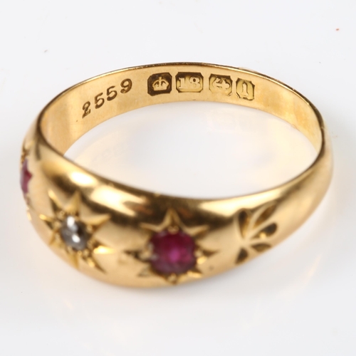 124 - An early 20th century 18ct gold three stone ruby and diamond gypsy ring, set with oval mixed-cut rub... 