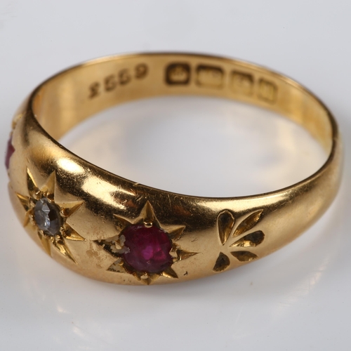 124 - An early 20th century 18ct gold three stone ruby and diamond gypsy ring, set with oval mixed-cut rub... 