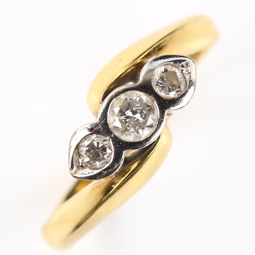 127 - A modern 18ct gold three stone diamond crossover ring, set with modern round brilliant-cut diamonds,... 