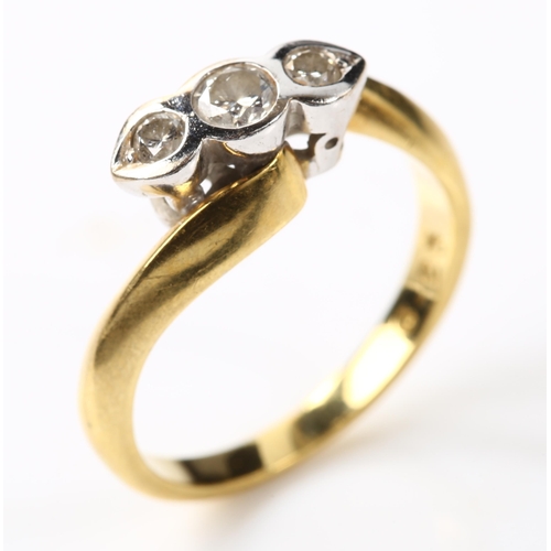 127 - A modern 18ct gold three stone diamond crossover ring, set with modern round brilliant-cut diamonds,... 