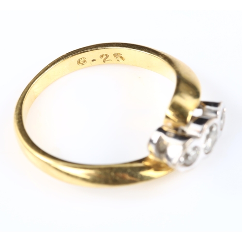 127 - A modern 18ct gold three stone diamond crossover ring, set with modern round brilliant-cut diamonds,... 