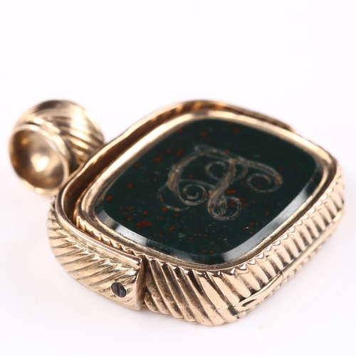 128 - An early 19th century unmarked rose gold bloodstone swivel seal memorial fob, with hinged panel open... 