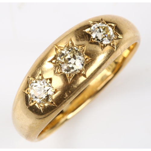 139 - An early 20th century 18ct gold three stone diamond gypsy ring, set with old European-cut diamonds, ... 