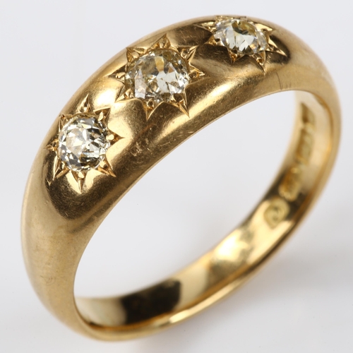 139 - An early 20th century 18ct gold three stone diamond gypsy ring, set with old European-cut diamonds, ... 