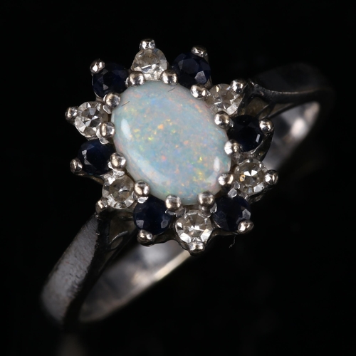 141 - A late 20th century 18ct white gold opal sapphire and diamond cluster ring, set with oval cabochon o... 