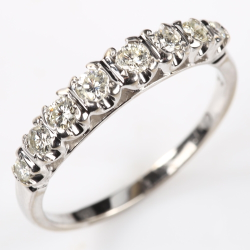 143 - A modern 18ct white gold graduated eight stone diamond half hoop ring, set with modern round brillia... 