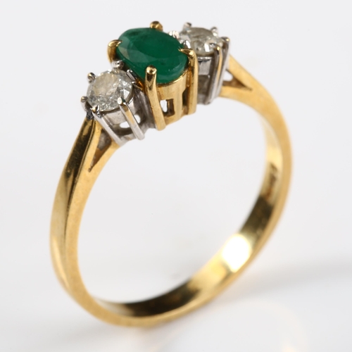 147 - A modern 18ct white gold three stone emerald and diamond ring, set with oval mixed-cut emerald and m... 