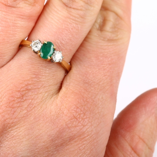 147 - A modern 18ct white gold three stone emerald and diamond ring, set with oval mixed-cut emerald and m... 