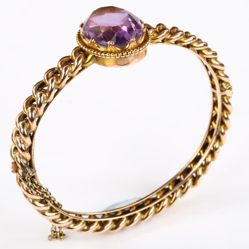 154 - A Victorian amethyst curb link hinged bangle, unmarked rose gold settings with oval mixed-cut amethy... 