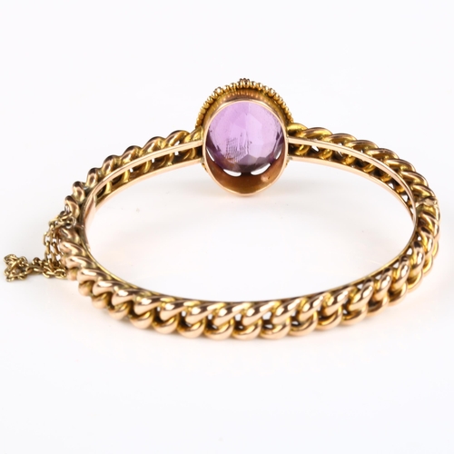 154 - A Victorian amethyst curb link hinged bangle, unmarked rose gold settings with oval mixed-cut amethy... 