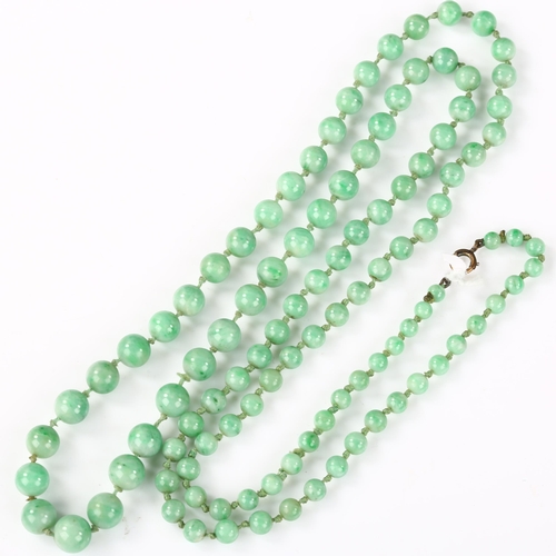 162 - A single-strand graduated jade bead necklace, individually knotted, bead diameters 8.7mm - 4.5mm, ne... 