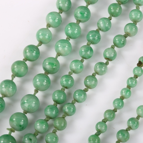 162 - A single-strand graduated jade bead necklace, individually knotted, bead diameters 8.7mm - 4.5mm, ne... 