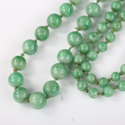 162 - A single-strand graduated jade bead necklace, individually knotted, bead diameters 8.7mm - 4.5mm, ne... 