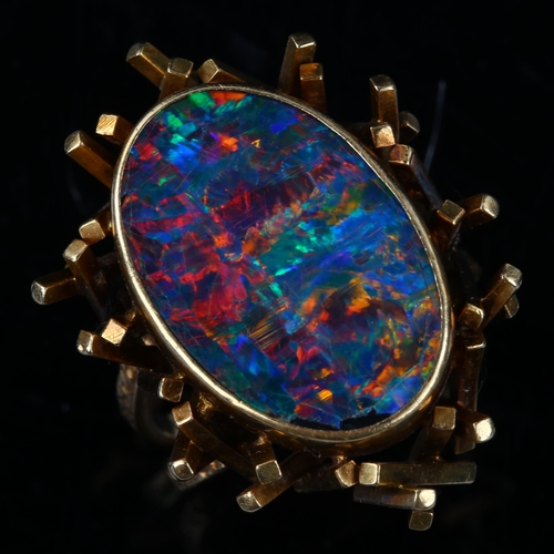 168 - A late 20th century 18ct gold black opal doublet abstract ring, with a cuboid tube basket and textur... 