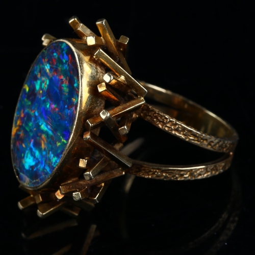 168 - A late 20th century 18ct gold black opal doublet abstract ring, with a cuboid tube basket and textur... 