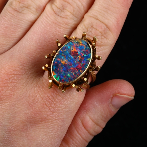 168 - A late 20th century 18ct gold black opal doublet abstract ring, with a cuboid tube basket and textur... 