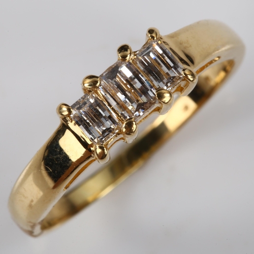 170 - A modern 18ct gold three stone diamond ring, set with rectangular barrel-cut diamonds, total diamond... 