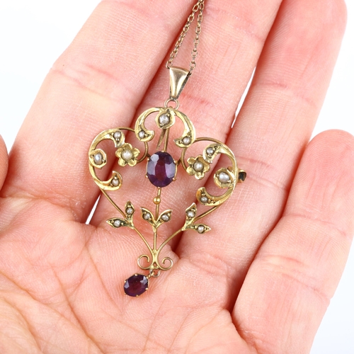 174 - An Art Nouveau 9ct gold amethyst and pearl openwork pendant necklace, on 9ct fine belcher link chain... 