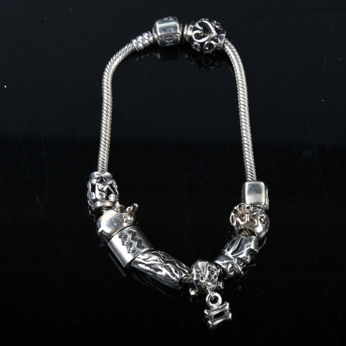 345 - PANDORA - a modern sterling silver snake link charm bracelet, with 9 silver charms, bracelet length ... 