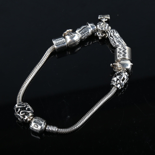 345 - PANDORA - a modern sterling silver snake link charm bracelet, with 9 silver charms, bracelet length ... 