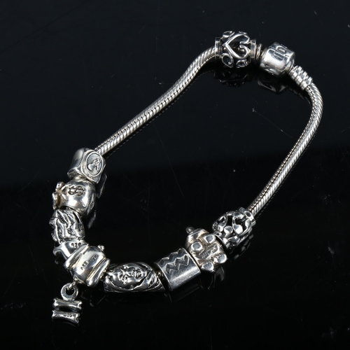 345 - PANDORA - a modern sterling silver snake link charm bracelet, with 9 silver charms, bracelet length ... 