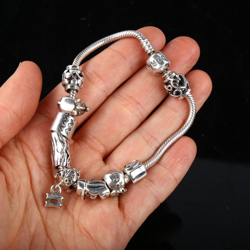 345 - PANDORA - a modern sterling silver snake link charm bracelet, with 9 silver charms, bracelet length ... 