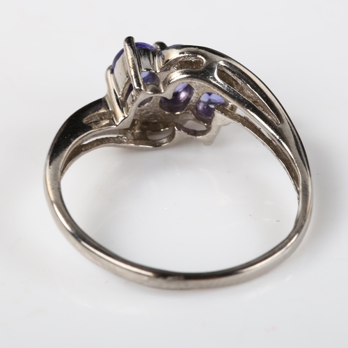 375 - A modern 9ct white gold tanzanite and diamond crossover ring, set with oval mixed-cut tanzanite and ... 