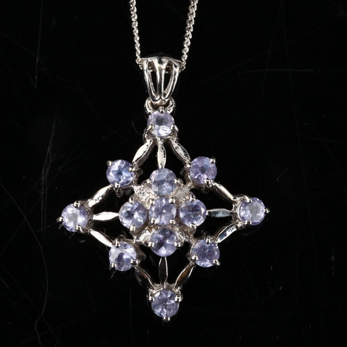 389 - A modern 9ct white gold tanzanite spider web pendant necklace, on 9ct fine flat curb link chain, pen... 