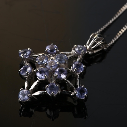 389 - A modern 9ct white gold tanzanite spider web pendant necklace, on 9ct fine flat curb link chain, pen... 