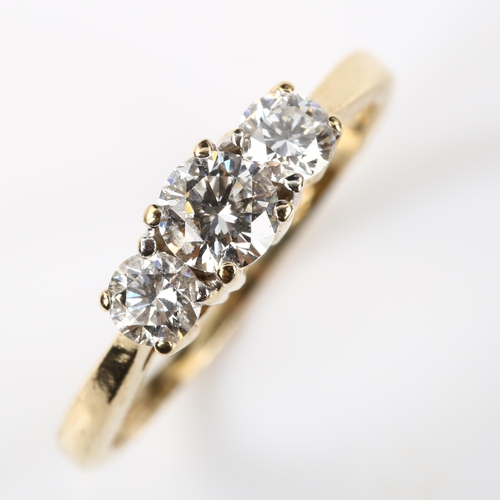 391 - A modern 14ct gold three stone diamond ring, set with modern round brilliant-cut diamonds, total dia... 