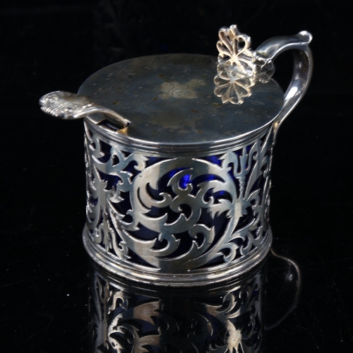 410 - A Victorian silver drum mustard pot and spoon, pierced foliate decoration with thumb piece, blue gla... 