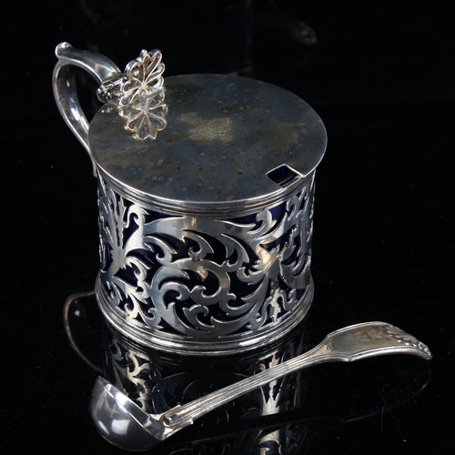 410 - A Victorian silver drum mustard pot and spoon, pierced foliate decoration with thumb piece, blue gla... 