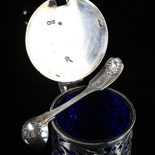 410 - A Victorian silver drum mustard pot and spoon, pierced foliate decoration with thumb piece, blue gla... 