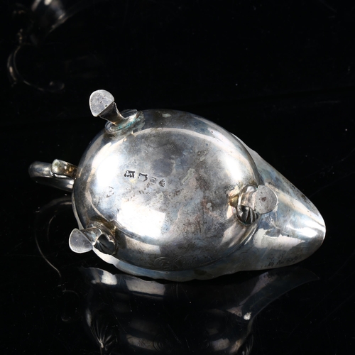 411 - A George II silver sauce boat, with a scalloped rim, scrolled acanthus leaf handle and hoof feet, by... 