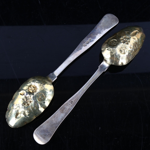 413 - A pair of Danish silver berry spoons, bright-cut engraved and relief embossed floral decoration with... 