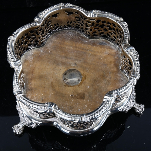 415 - A Victorian silver-mounted oak wine bottle coaster, lobed form with relief embossed beaded edge, pie... 