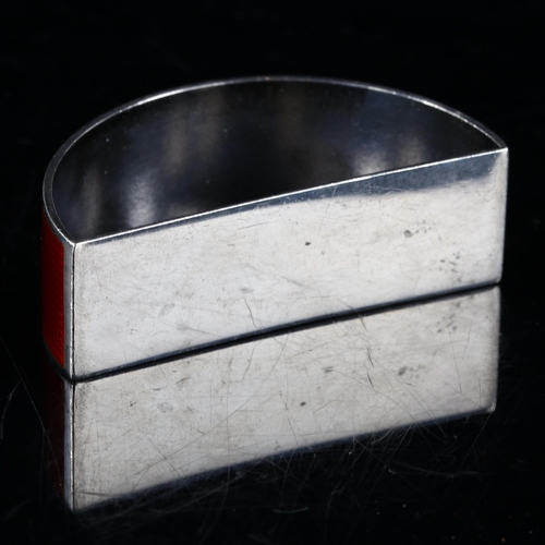 439 - EGON LAURIDSEN - a Danish stylised sterling silver and red enamel demilune napkin ring, engine turne... 