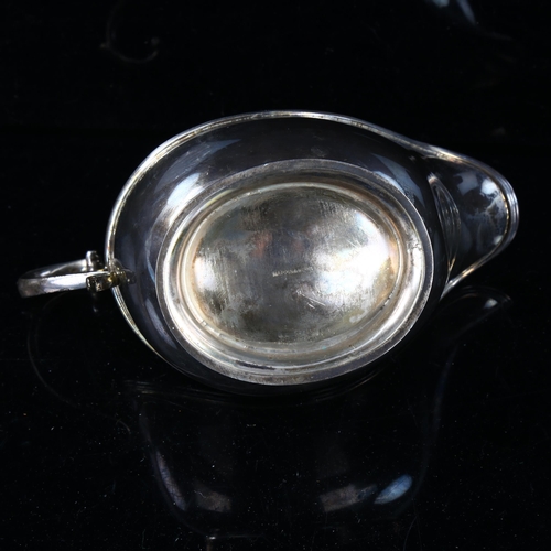 455 - MAPPIN & WEBB - a George V silver sauce boat, pedestal form with reeded rim and a scrolled acanthus ... 