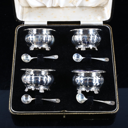 492 - A cased set of 4 Edward VIII silver salt cellars and spoons, lobed pumpkin form, with foliate shell ... 