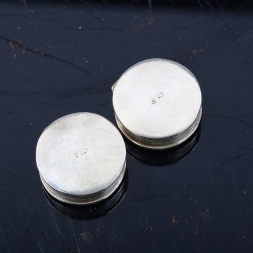 426 - A pair of silver printed porcelain dog pillboxes, diameter 3cm (2)