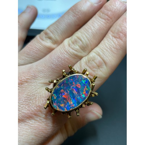 168 - A late 20th century 18ct gold black opal doublet abstract ring, with a cuboid tube basket and textur... 