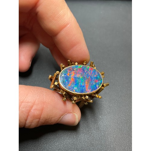 168 - A late 20th century 18ct gold black opal doublet abstract ring, with a cuboid tube basket and textur... 