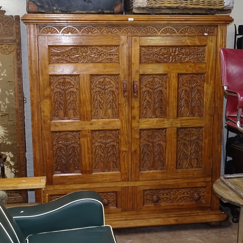 2297 - An Anglo-Indian teak and camphorwood cabinet, with 2 panelled doors and relief carved drawers under,... 