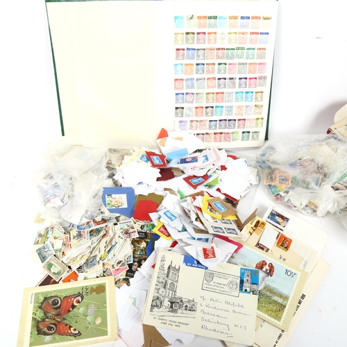 134 - A large quantity of Vintage loose postage stamps and stamp albums