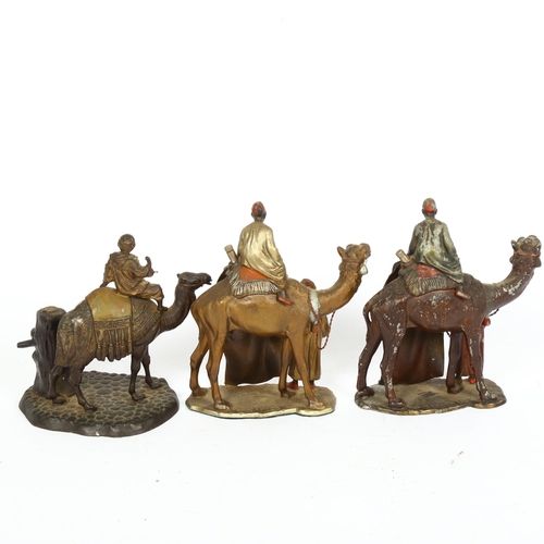 174 - 3 Austrian cold painted spelter table lighters, in the form of a camel and rider, height 16cm