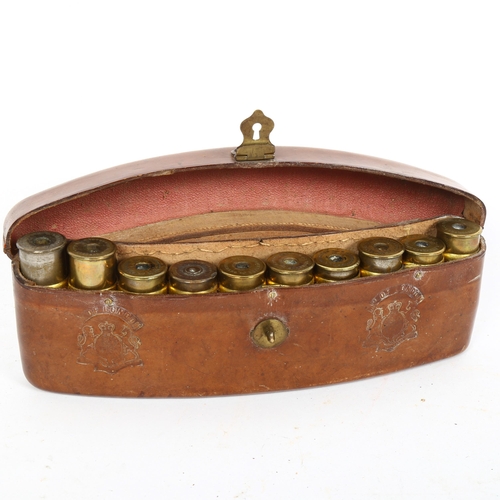 178 - A 19th century curved tan leather 10-section shotgun cartridge case, with embossed crest and empty s... 