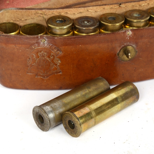 178 - A 19th century curved tan leather 10-section shotgun cartridge case, with embossed crest and empty s... 